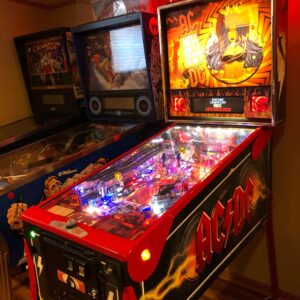 ac/dc pro pinball machine in a game room